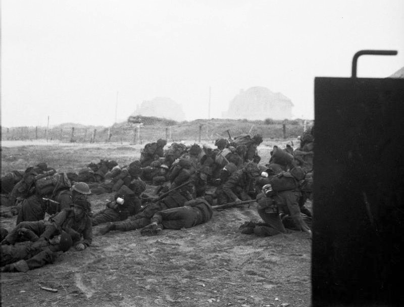 Infantry waiting to move off 'Queen White' Beach, Sword.