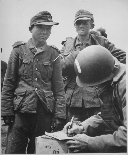 Osttruppen were recruits from Russia and the East. Some, like the above solider being registered with an American POW handler, came from as far away as Korea.