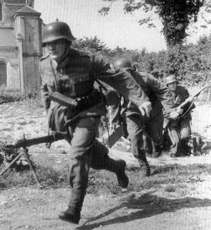 German Soldiers of the 709 Infantry Division, abandon their refuge and rush to their positions in Montebourg, Normandy in June 1944.